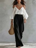 Nicoletta | Completo con top bianco a spalle scoperte e pantaloni neri a palazzo